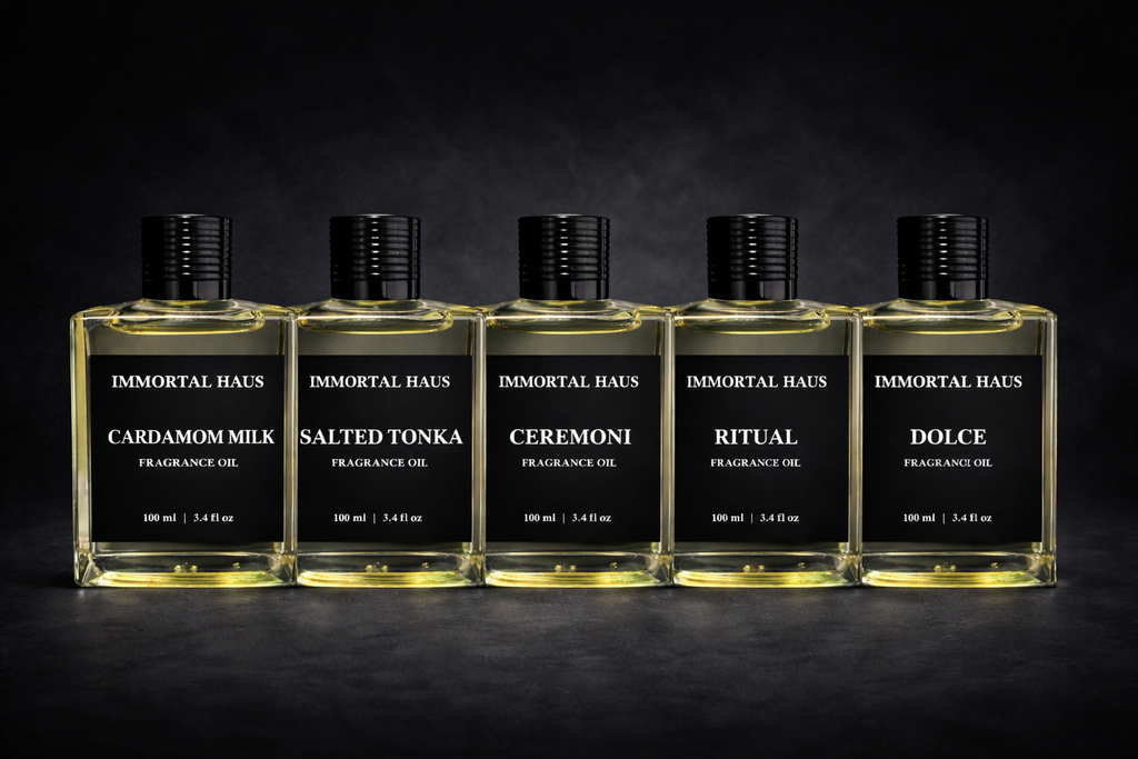 Five bottles of Immortal Haus fragrance oils on a dark background