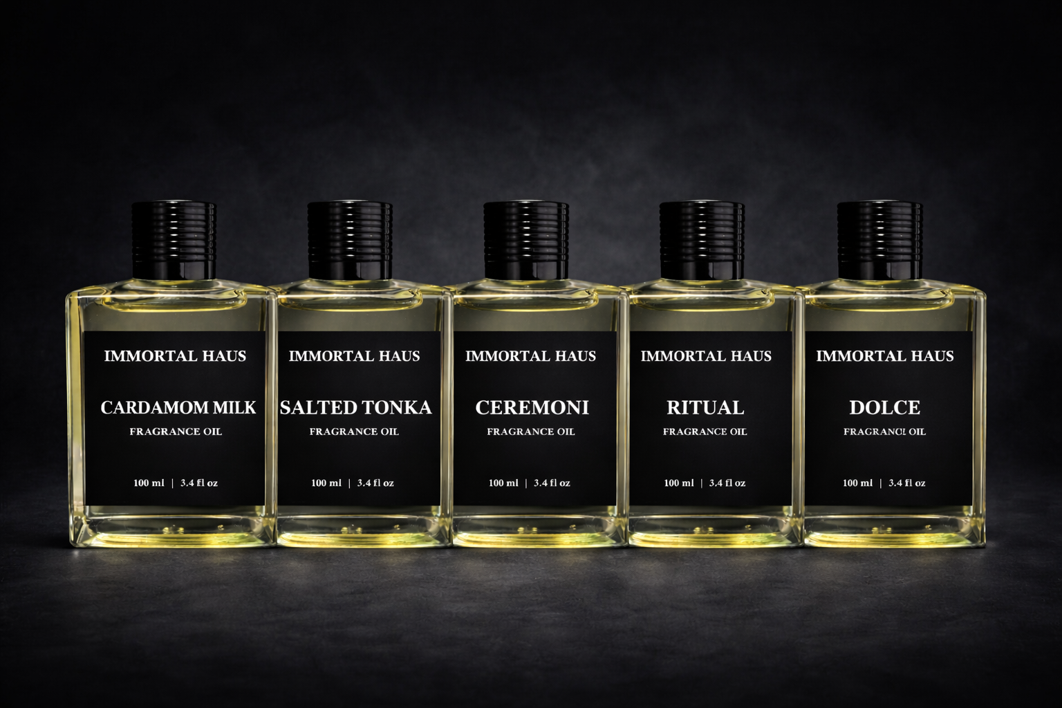 Five bottles of Immortal Haus fragrance oils on a dark background