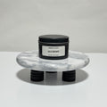 Alchemy travel candle in charcoal gray tin, amber and plum scent, 6.3 oz single wick