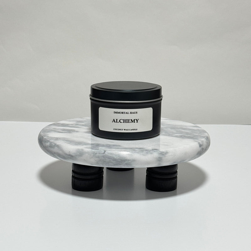 Alchemy travel candle in charcoal gray tin, amber and plum scent, 6.3 oz single wick
