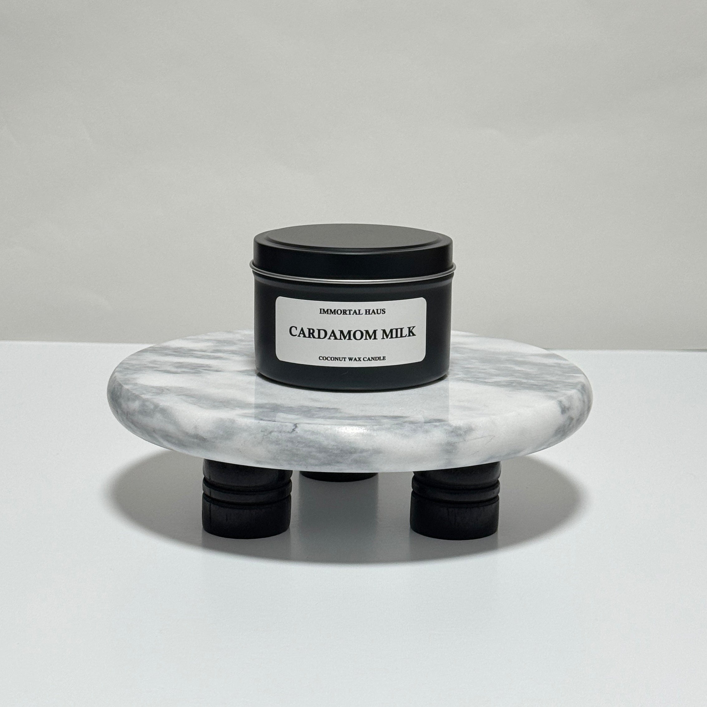 Cardamom Milk travel candle in charcoal gray tin, vanilla and cinnamon scent, 6.3 oz single wick